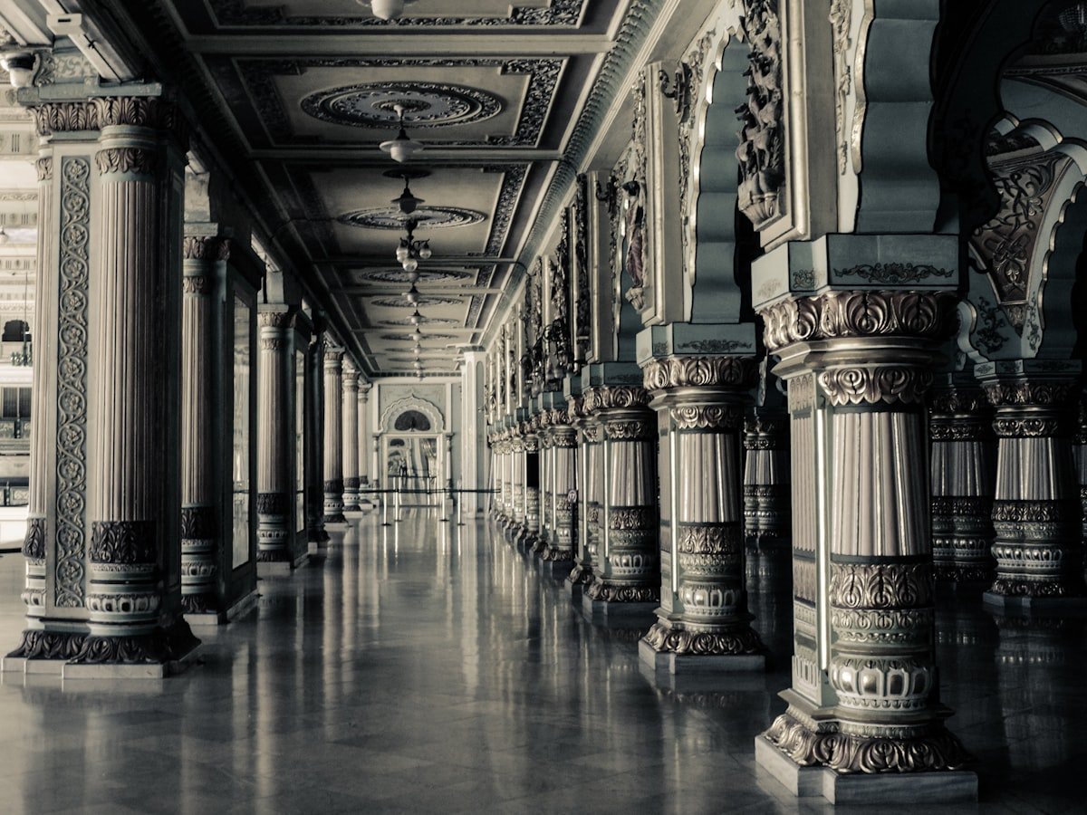 A grand institutional colonnade receding into the distance — the architecture supporting the Academy