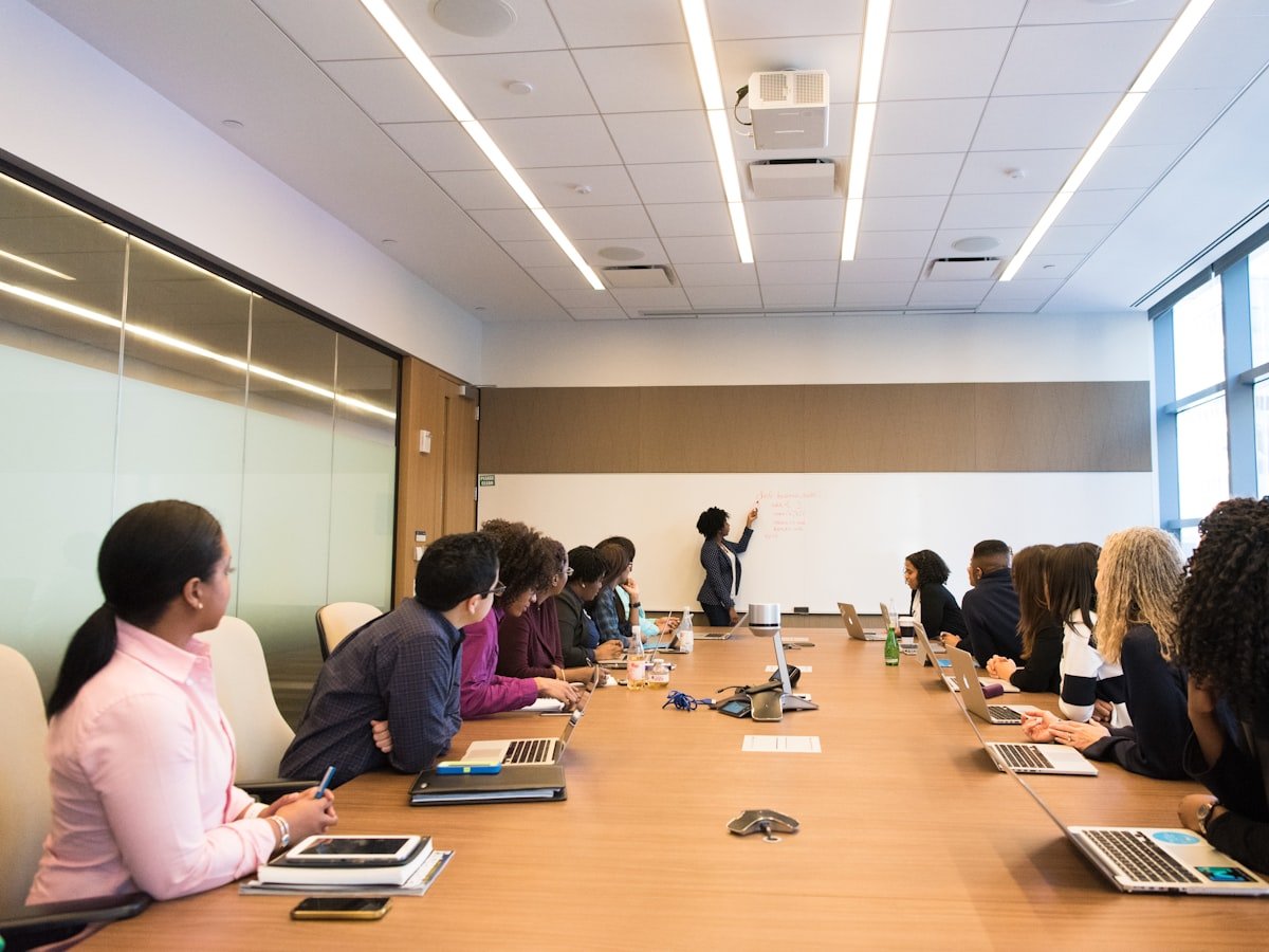 Members and mentors gathered around a roundtable — education and collaboration in motion